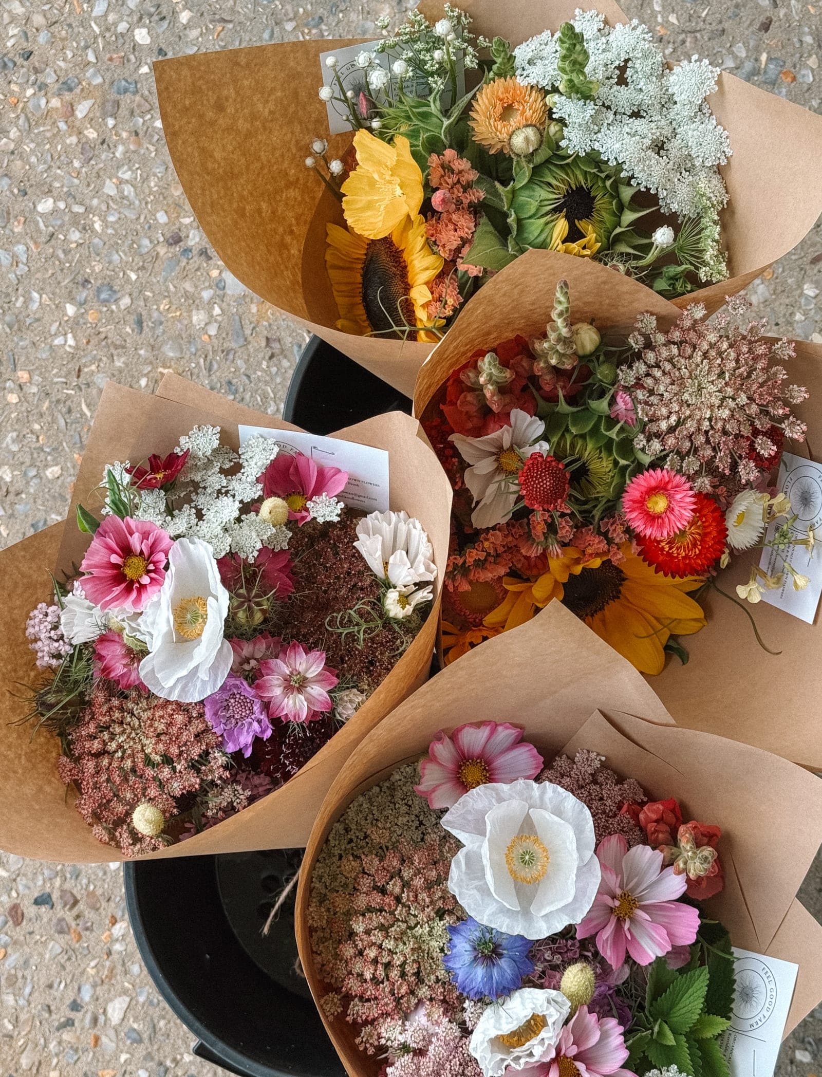 Four wrapped bouquets laid out, ready to go out for the week.