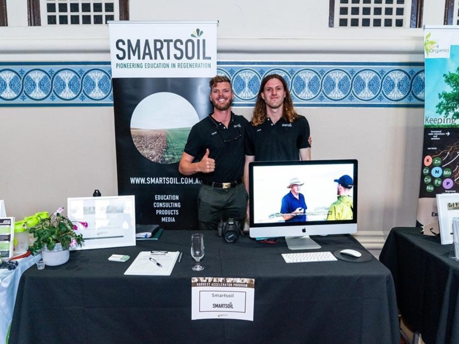David and his brother at the Smartsoil stand, beneath the Smartsoil banner.